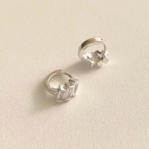 Macro view of 925 sterling silver earrings with three rectangular clear cubic zirconia stones