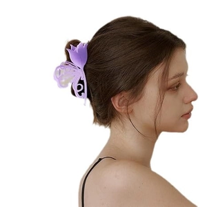 Elegant purple matte tulip butterfly hair claw clip worn on model side view