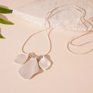 Minimalist matte silver pleated petal necklace with long snake chain on stone base