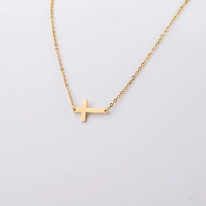 Detail shot of the polished gold finish on the horizontal cross pendant necklace