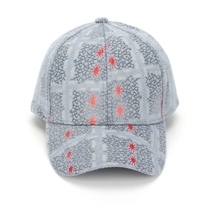 Detailed close-up of grey baseball cap featuring red star patterns and black grid texture