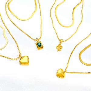 Double-layered gold titanium steel necklaces with heart, snake, and green gemstone pendants