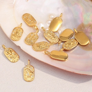 Detail of 18K gold-plated stainless steel zodiac charms on elegant shells and pearls