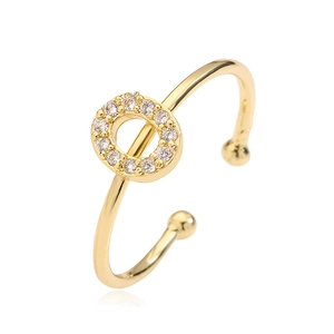 Detailed macro view of a gold-plated letter ring featuring sparkling zircon inlay accents