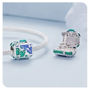 Macro view of S925 silver suitcase charm featuring blue enamel and star pattern
