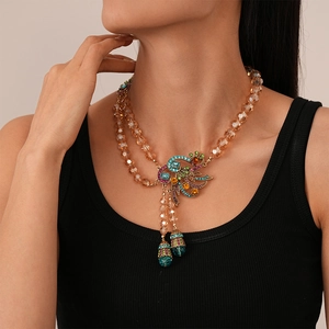 Detail of layered champagne crystal beads with a rhinestone peacock pendant necklace