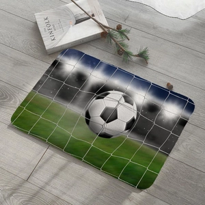 Flat lay of soccer goal pattern flannel mat on grey wood floor with cozy home decor