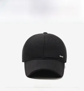 Detailed front view of black winter baseball cap with silver metal buckle and wool texture