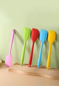 Five assorted colors of heat-resistant silicone spatulas with integrated hanging holes