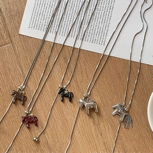 Ins-style stainless steel snake chain necklace with colorful pony charms on wood background