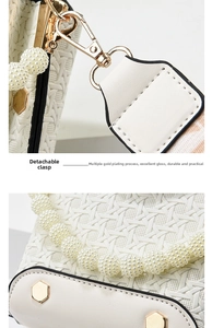 Close-up of white woven bag with detachable gold buckle and elegant pearl chain