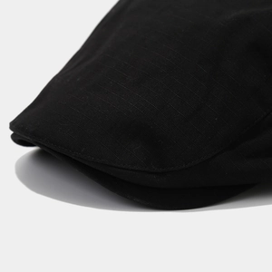 Detailed close-up of neat stitching and twill texture on a black quick-dry cap brim