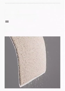Detail showing the washable PVC silk loop mat being rinsed with water for easy cleaning