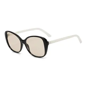 Chic oversized two-tone black and white sunglasses with light brown tinted lenses