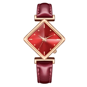 Détail macro du bracelet en cuir bordeaux et du boîtier carré en or rose de la montre