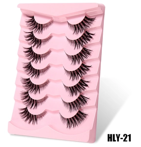 Detailed macro view of 7 pairs of fox-eye false eyelashes in a pink display tray