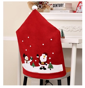 Detail of red Santa Claus chair cover with white pompom in a festive home setting