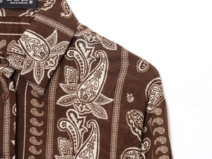 Detail of paisley printed shirt collar and buttons with size label on woven fabric
