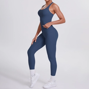 Detail of dark blue yoga set showing racerback top and leggings with side phone pockets