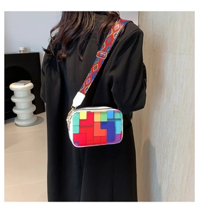 Detail of colorful geometric pattern crossbody bag with wide bohemian shoulder strap
