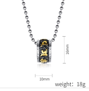 Macro view of cylinder prayer wheel pendant with lotus motifs in silver and gold