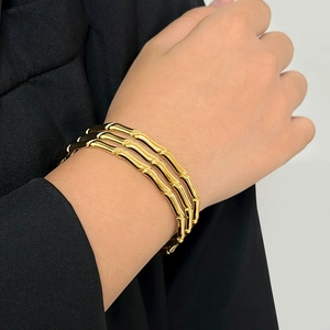 Macro shot of gold-plated bamboo-shaped triple-layer stacked bangle on wrist