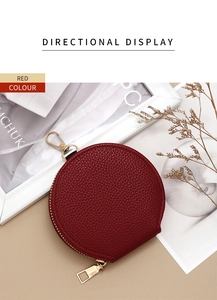 Detail of red pebbled leather mini round coin purse with gold zipper and hook