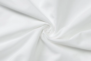 Macro shot of white smooth fabric showing high-quality draping and fine fiber texture