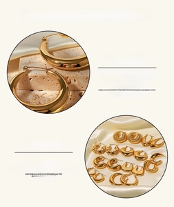 Detail of gold stainless steel hoop earrings set with vacuum plating on silk background