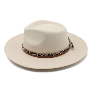Detail of cream fedora hat featuring leopard print and brown leather decorative band