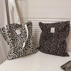 Retro leopard print canvas tote bag in beige and dark coffee with woven brand label