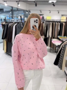 Pink floral crewneck knit sweater with long sleeves in a relaxed fit for women