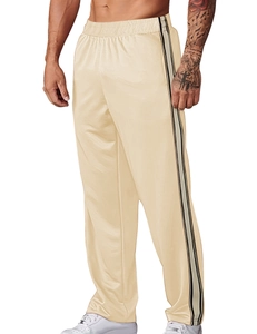 Detail view of beige joggers with black and white side stripes for a sporty athletic look