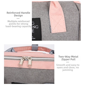 Detail of reinforced handles and smooth dual metal zippers on Oxford fabric diaper bag