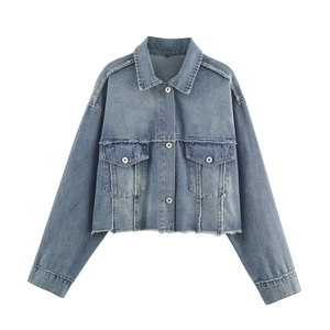 Women's blue cropped denim jacket with distressed frayed edges and buttoned chest pockets