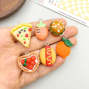 DIY resin food pendants including pizza, carrot, burger and strawberry on hand