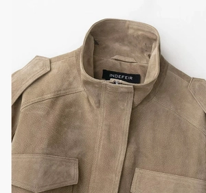 Detail of khaki suede jacket collar with epaulets and stitched brand label
