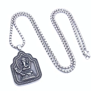 Detailed macro view of vintage titanium steel Ganesha pendant with elegant box chain necklace