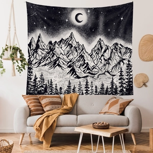Detailed macro of black and white bohemian mountain tapestry with crescent moon and stars