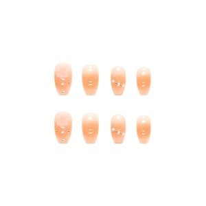 Peach pink gradient press-on nails with 3D embossed flowers and pearl accents