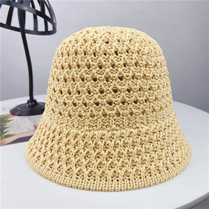 Detail of hollow woven texture on beige summer bucket hat with breathable crochet pattern