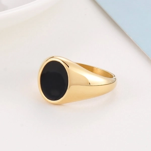 Minimalist stainless steel ring in gold with a black oval surface and sleek design