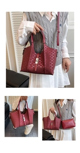 Detail view of the wine red tote bag with letter patterns and inner pouch on model