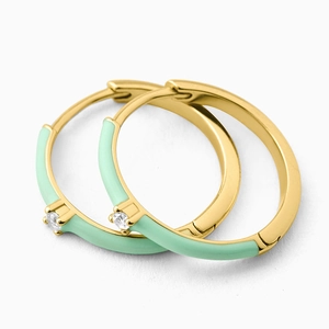 Detailed macro view of mint green enamel hoop earrings with gold plating and zircon