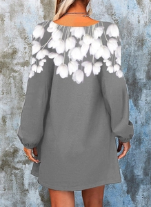 Detail of grey mini dress featuring white floral prints on neck and back of the dress