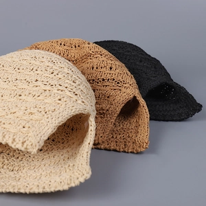 Close-up of hollow knit straw bucket hats in beige, khaki, and black showing textures