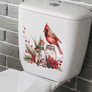 Détail d'autocollant oiseau cardinal de Noël et baies sur réservoir de WC blanc