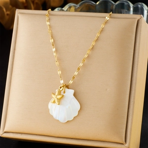 Detail of 18K gold-plated chain with white shell pendant and small golden starfish