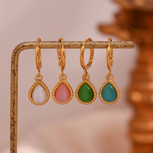Detailed display of teardrop cat eye stone earrings in white, pink, green, and blue colors