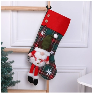 Detail of red and green plaid Christmas stocking with 3D plush gnome on a rustic ladder
